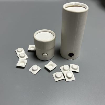 Custom pulp button for tube packaging
